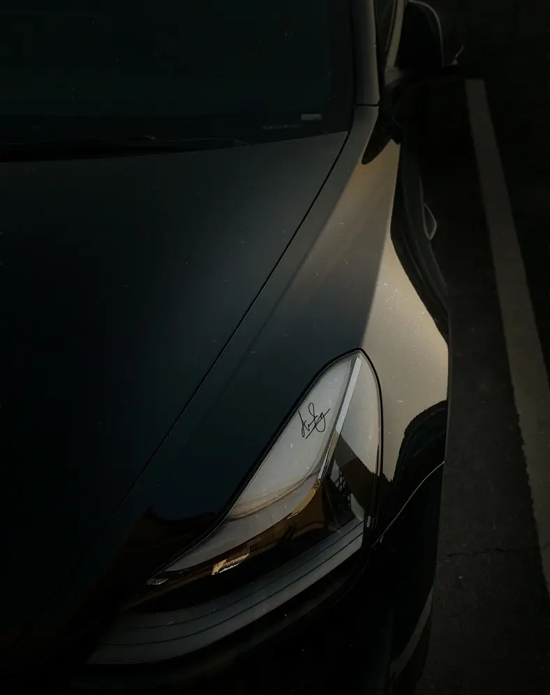Signature UV DTF sticker on car headlight at night