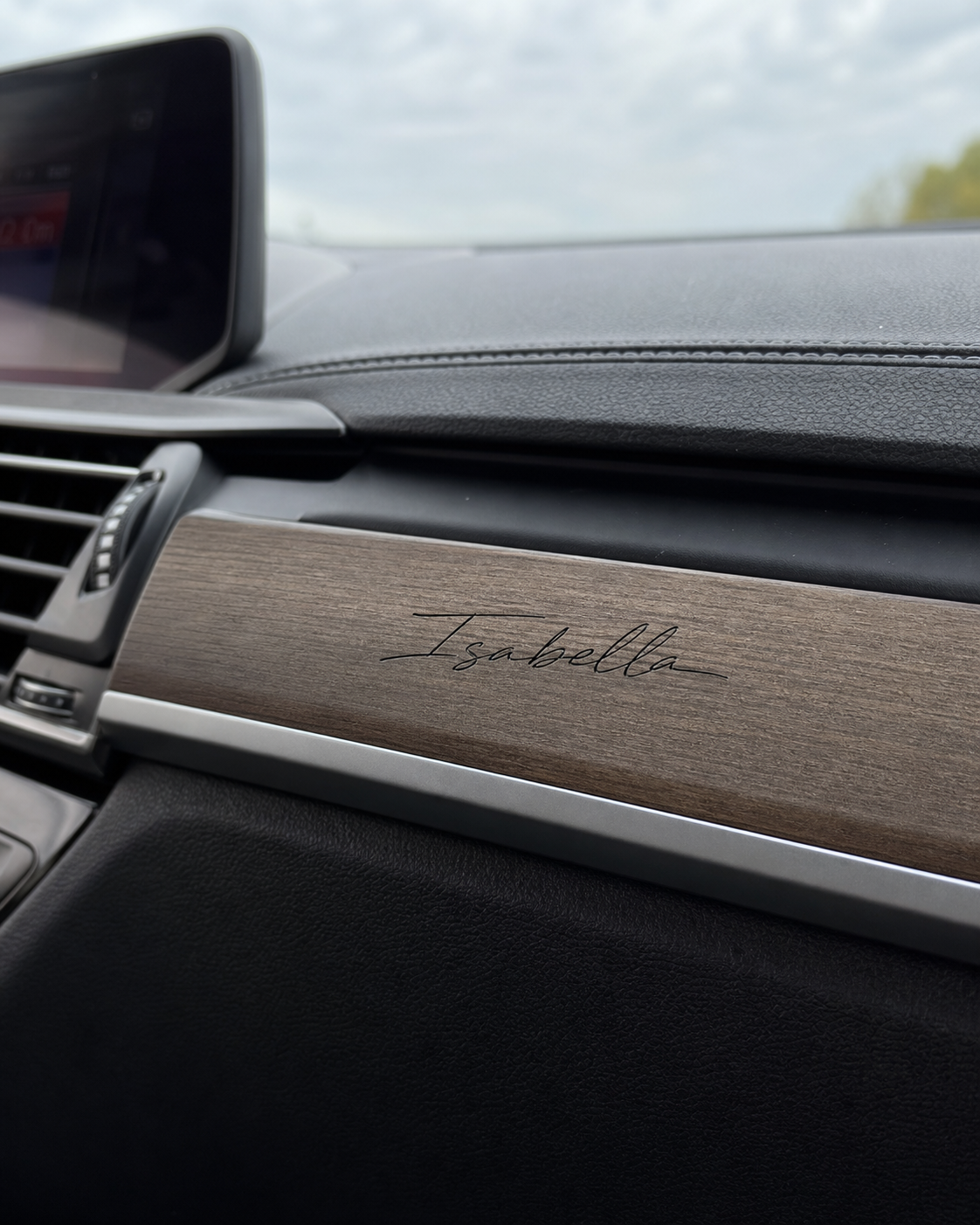Isabella signature applied to wood dashboard trim